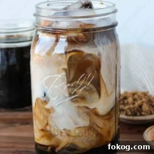 Iced Brown Sugar Latte Recipe — Creamy Cold Coffee Drink 11 Iced brown sugar coffee and milk swirled in a large mason jar.