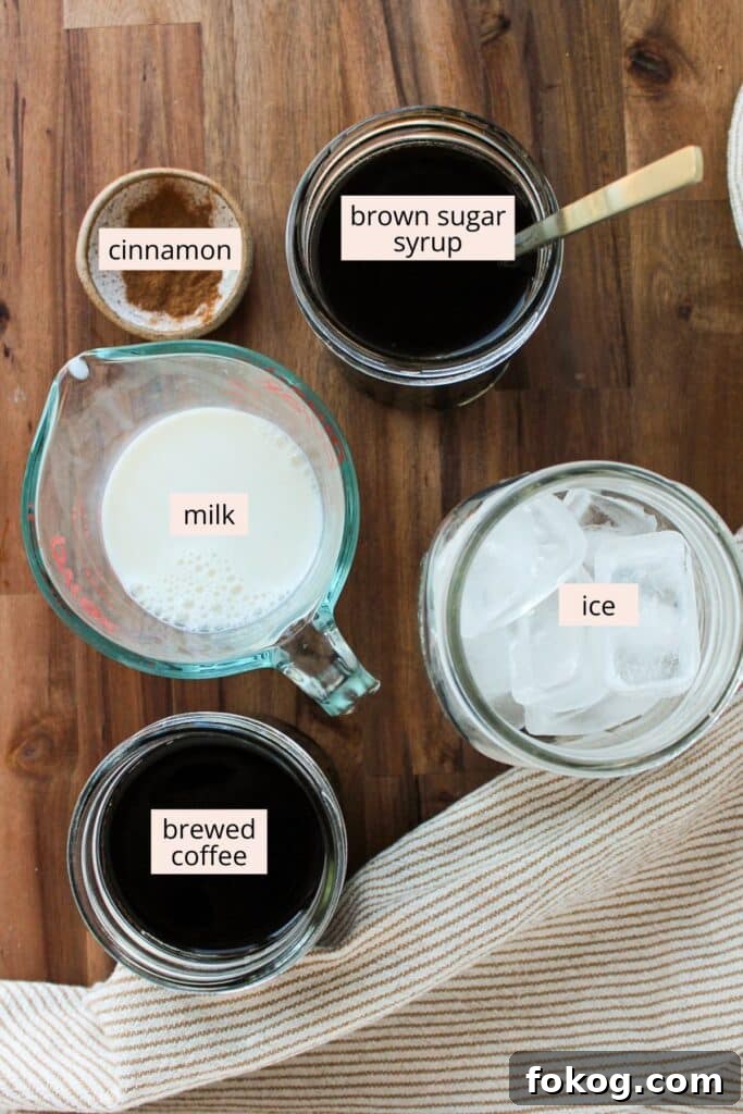 Iced Brown Sugar Latte Recipe — Creamy Cold Coffee Drink 3 Coffee, brown sugar syrup, milk, ice and cinnamon in containers with labels.