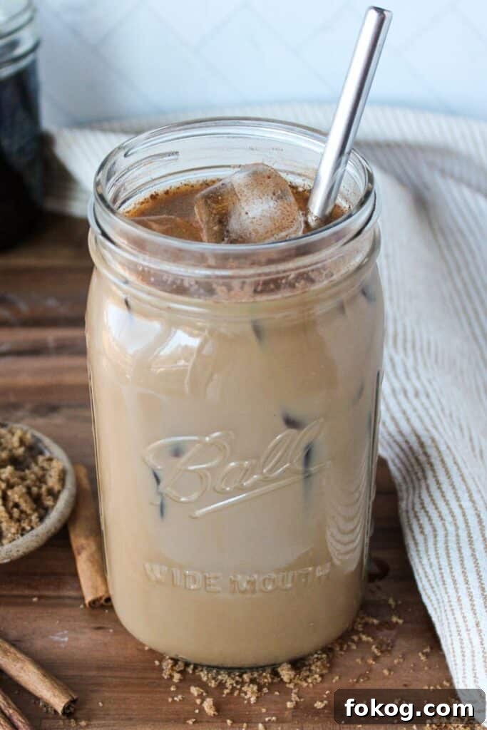 Iced Brown Sugar Latte Recipe — Creamy Cold Coffee Drink 10 A large mason jar full of brown sugar coffee and ice.