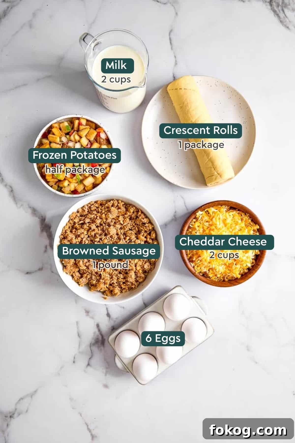 Festive Christmas Breakfast Casserole with Sausage and Cheese 4 Ingredients for Christmas breakfast casserole, including milk, crescent rolls, frozen potatoes, sausage, cheese, and eggs.