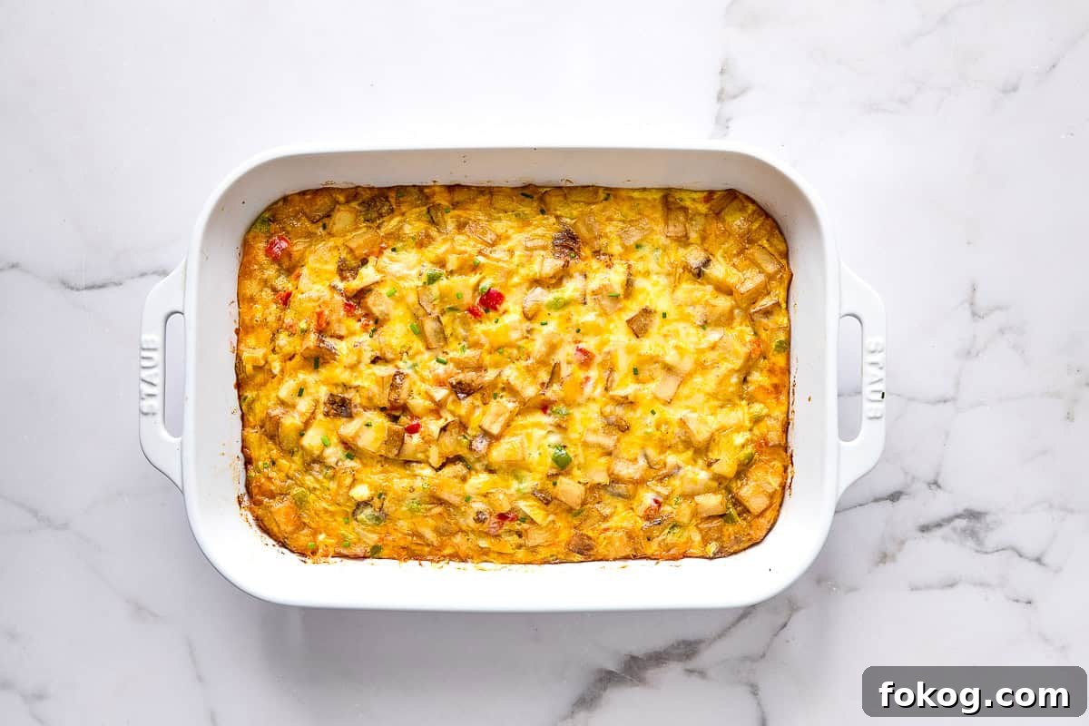 Festive Christmas Breakfast Casserole with Sausage and Cheese 8 Christmas morning casserole in baking dish.
