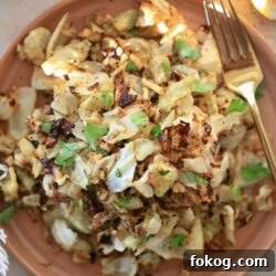 roasted green cabbage on brown plate with green fork
