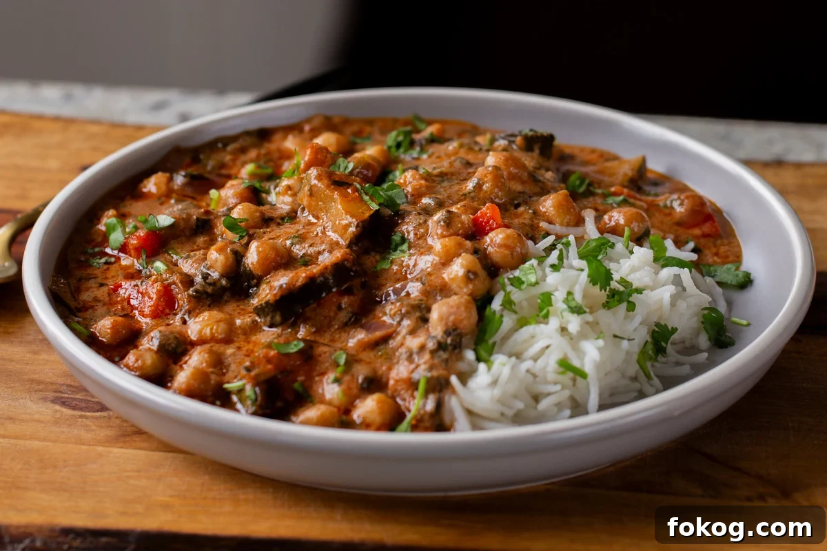 chickpea zucchini curry in a bowl with rice