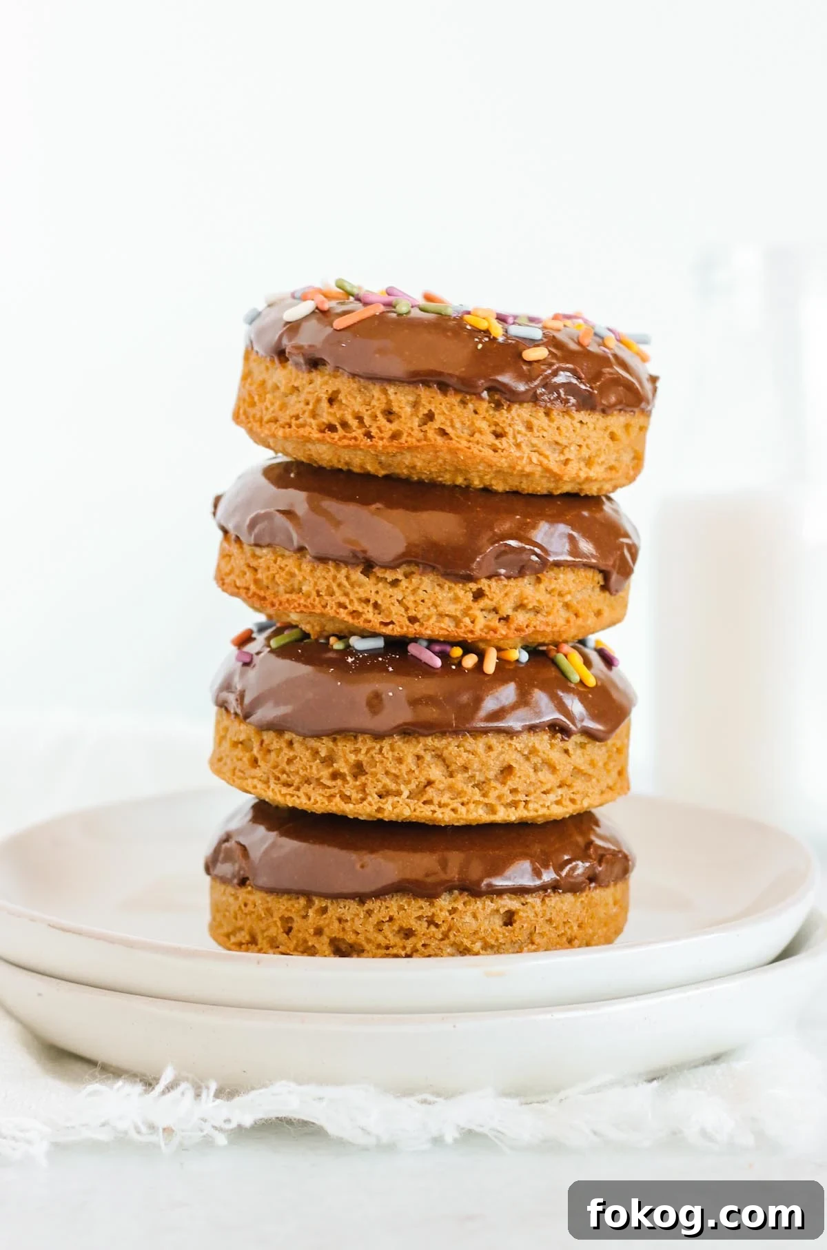 Donuts with chocolate frosting stacked 4 high.