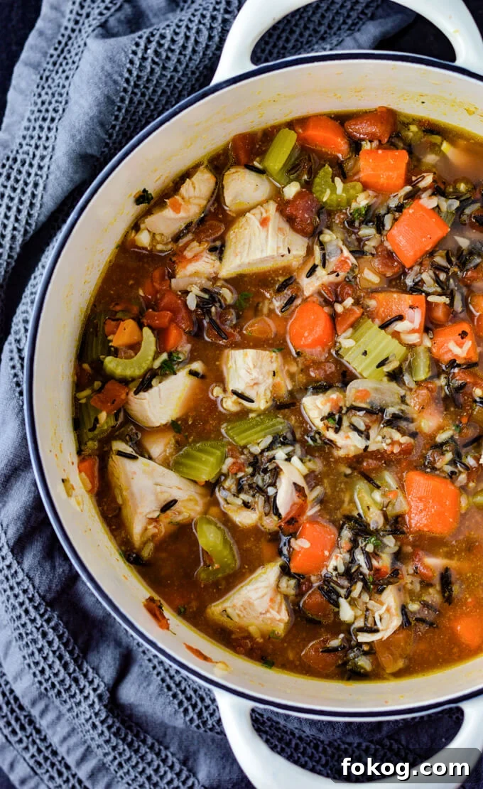 Hearty Chicken and Wild Rice Soup Recipe for Cozy Nights 7 A Dutch oven of wild rice chicken soup with carrots, onions and celery.