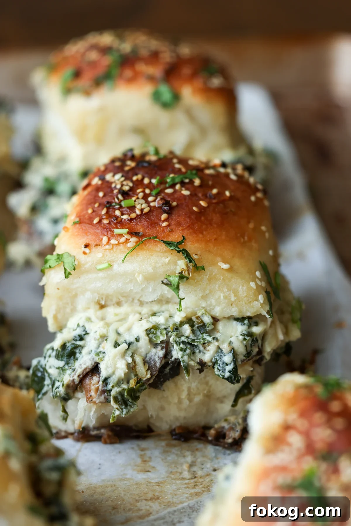 close-up of cheesy mushroom sliders on the baking sheet after baking