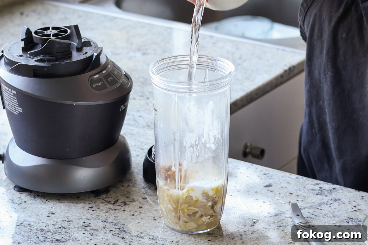 adding cashew cream ingredients to the blender