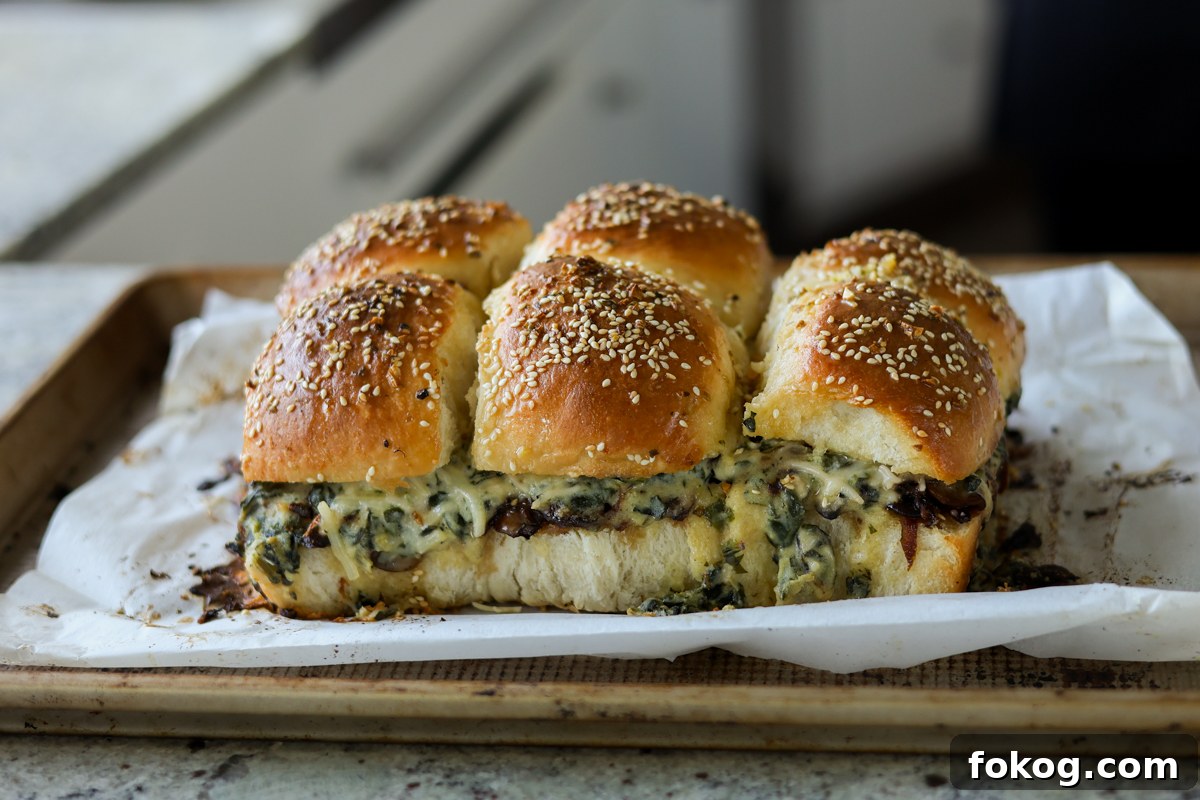 cheesy mushroom sliders on the baking sheet after baking