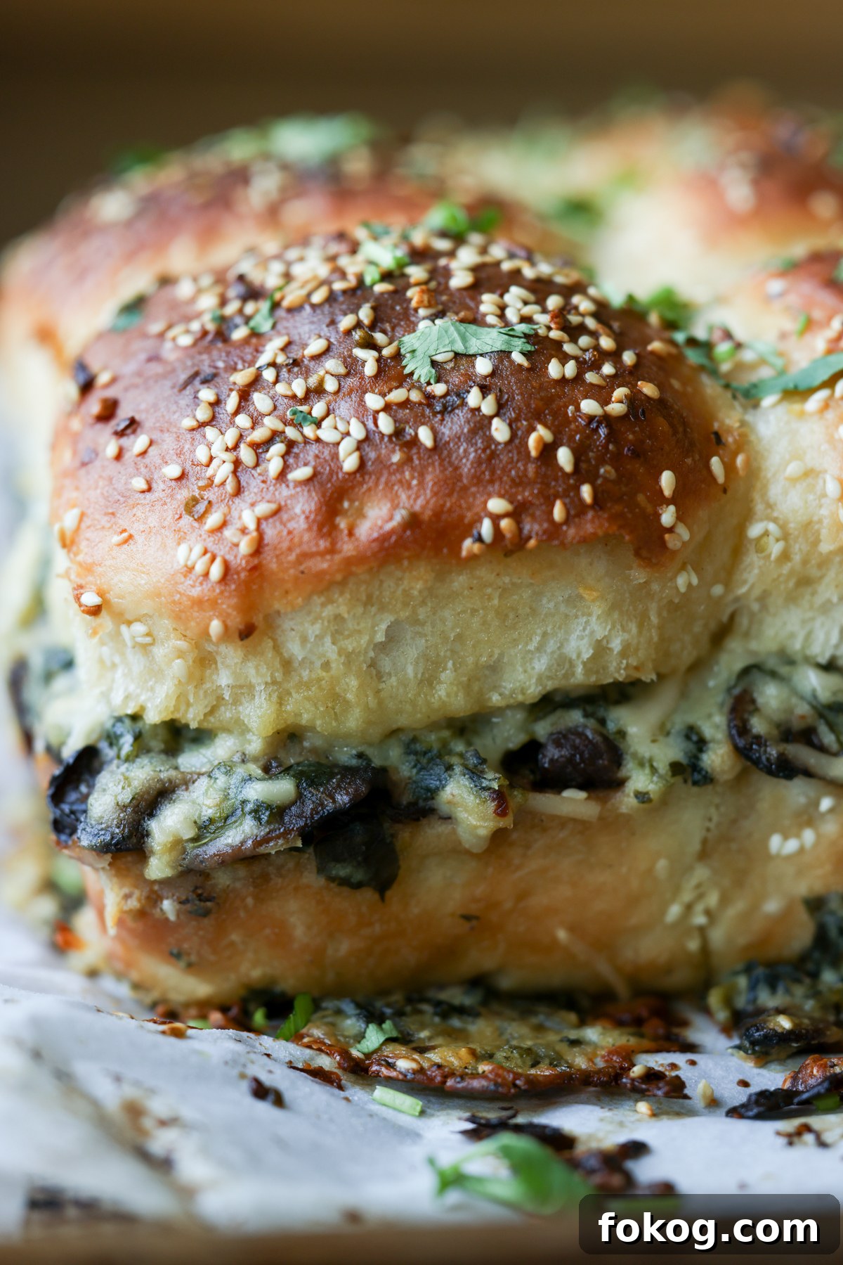 close-up of cheesy mushroom sliders on the baking sheet after baking