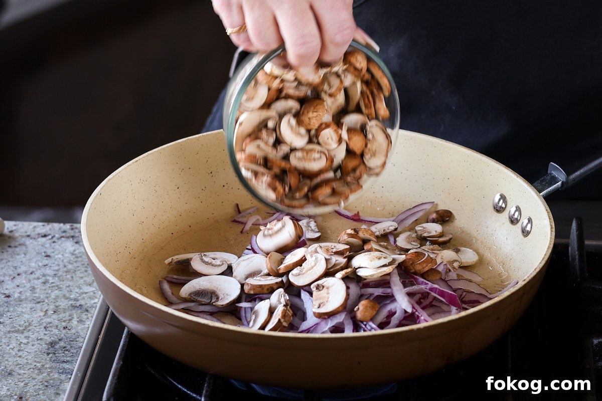 adding mushrooms to the pan