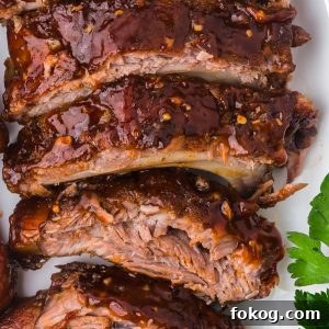 Baked Ribs - Tender ribs seasoned with a bold, flavorful sauce are baked in the oven until the meat is fall-off-the-bone. Comfort on a plate!