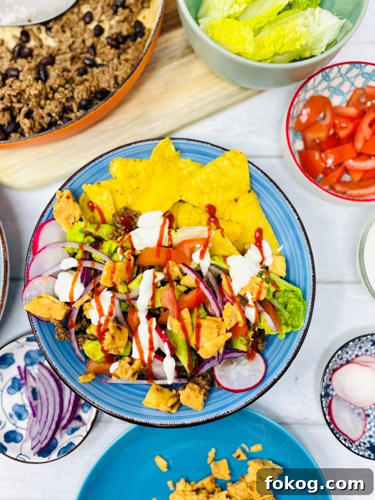 Light Summer Dinner Ideas: Quick Recipes for Warm Evenings 7 beef taco salad with sour cream and chilli sauce drizzle on top