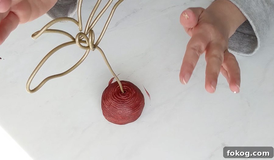 Insert wire sculpture into painted clay base