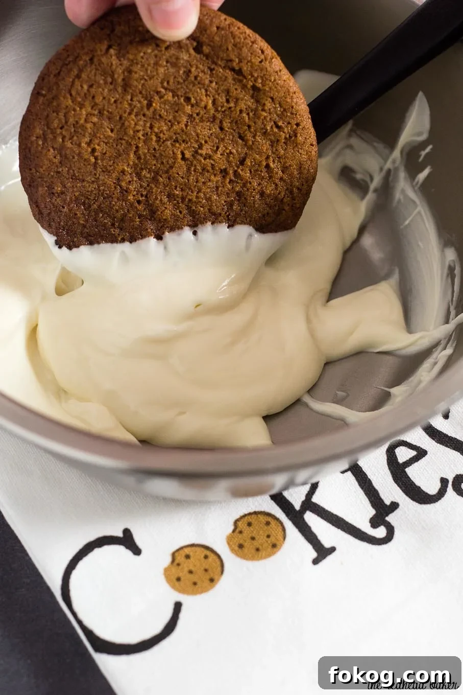 Warmly spiced gingerbread cookies get fancy for the holidays with a dip in white chocolate. Santa will love getting these cookies on Christmas Eve! 