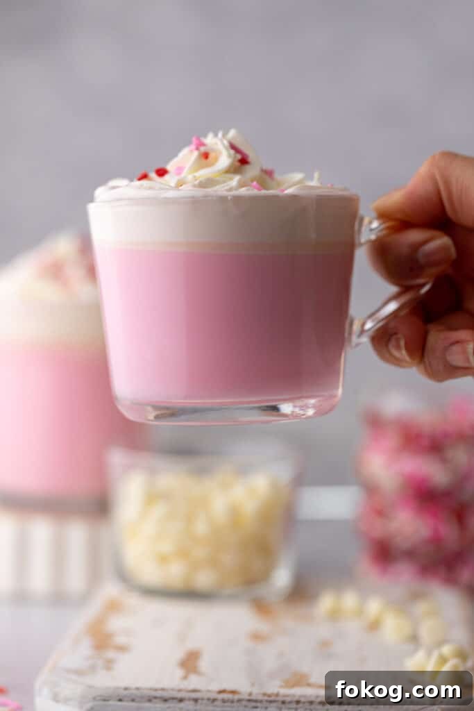Hand holding pink valentine's day hot chocolate