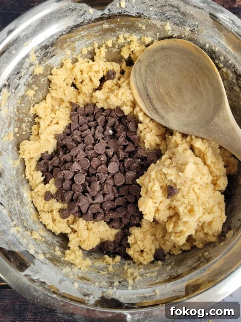 Crispy Edges, Chewy Centers: Ultimate Chocolate Chip Cookies 8 Mixing bowl filled with cookie dough, loaded with chocolate chunks.