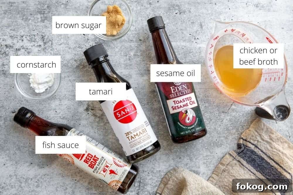 All of the ingredients for the beef lettuce wraps sauce recipe, arranged on a surface with labels.