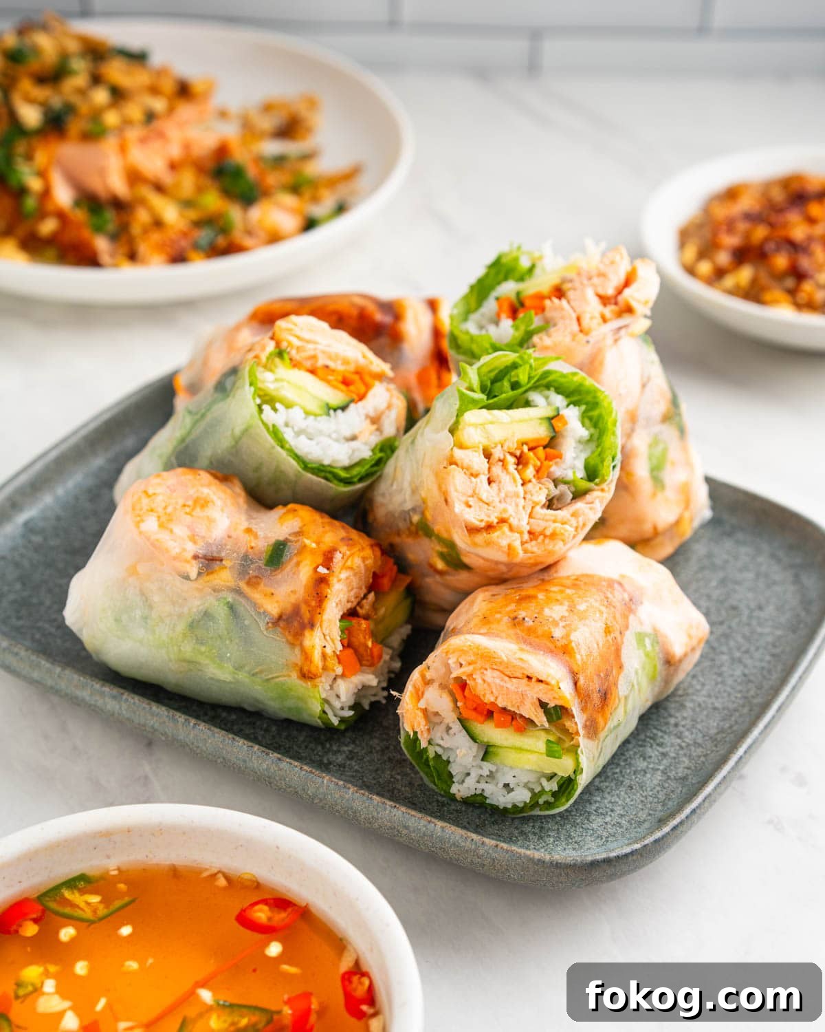 6 salmon spring rolls cut in half and stacked.
