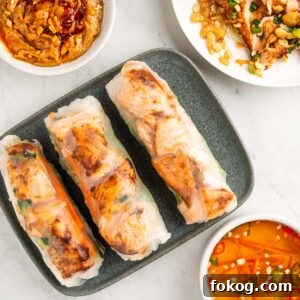 Plate of salmon spring rolls with fish sauce dip and peanut sauce.