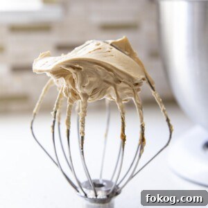 Peanut butter frosting on a wire whip.