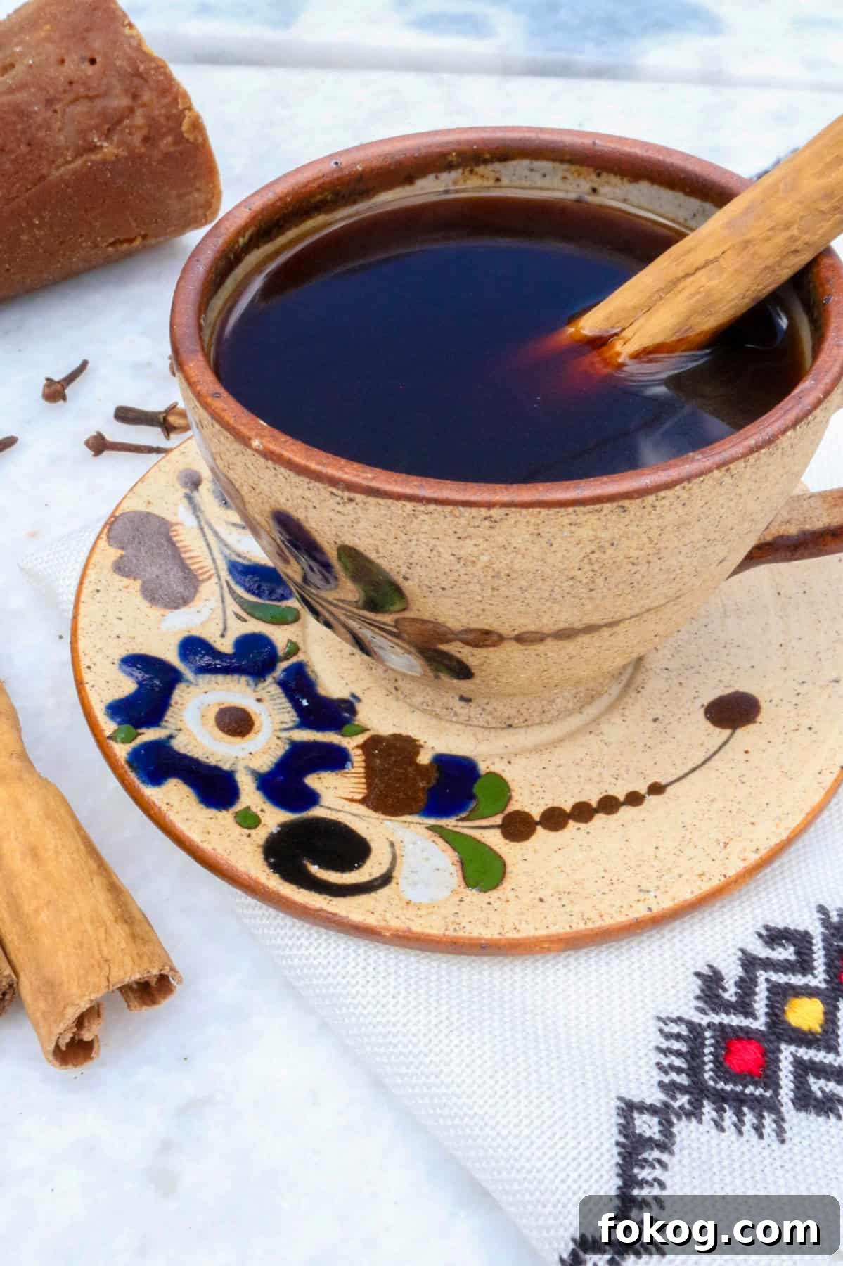Authentic Cafe de Olla Recipe, coffee in a mug with a cinnamon stick