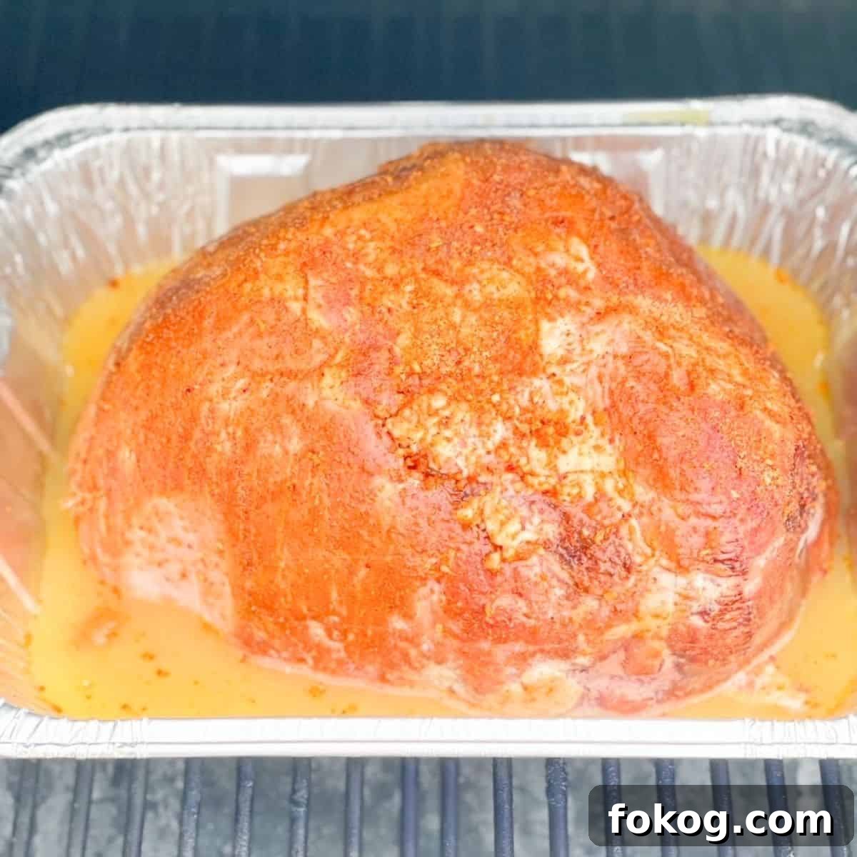The prepared ham placed on the pellet grill.