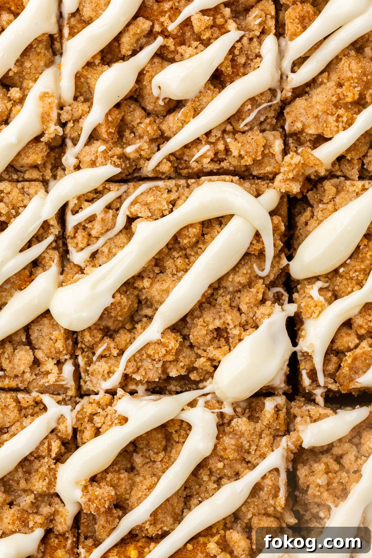 Baked gluten-free pumpkin coffee cake in a pan topped with golden brown cinnamon streusel crumbs.