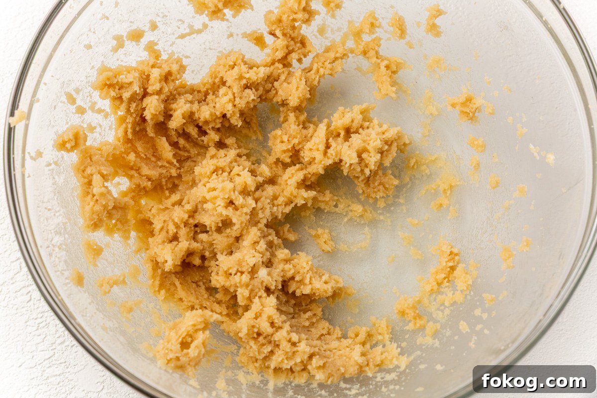 Butter and sugars creamed together in a glass bowl until light and fluffy for gluten-free pumpkin coffee cake batter.
