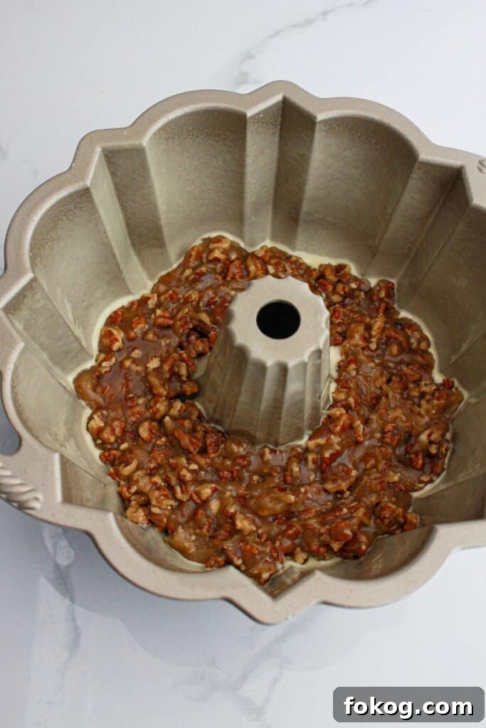 pecan topping in a greased bundt cake pan.