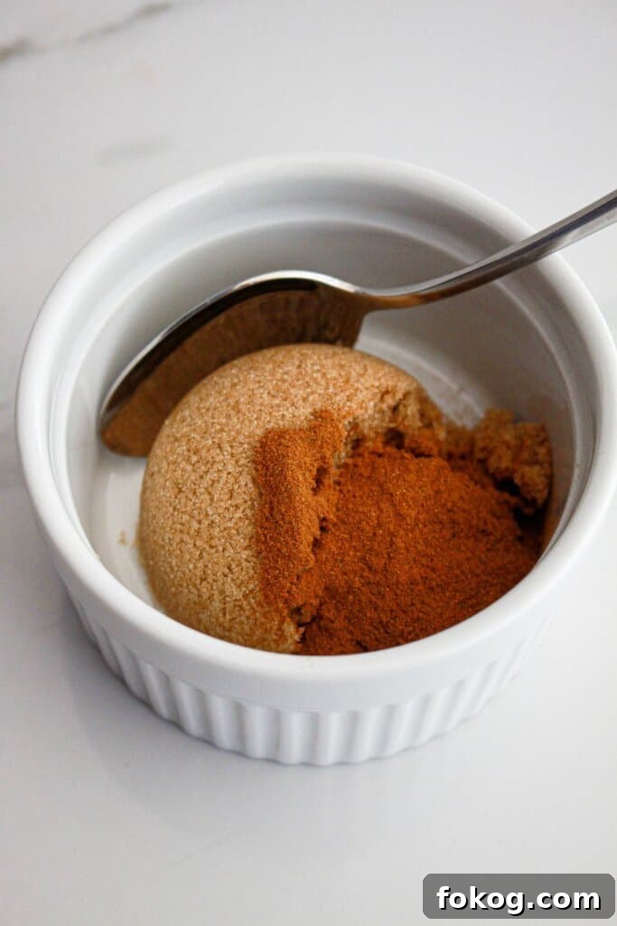 cinnamon and brown sugar being mixed together in a small bowl.