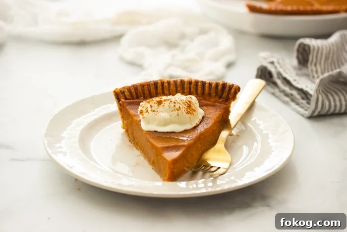 southern sweet potato pie on a plate topped with whipped cream.