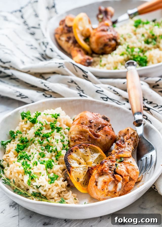 41 Juicy Chicken Drumstick Recipes You’ll Want Tonight 12 Lemon Garlic Roasted Chicken Legs on a plate serve with white rice