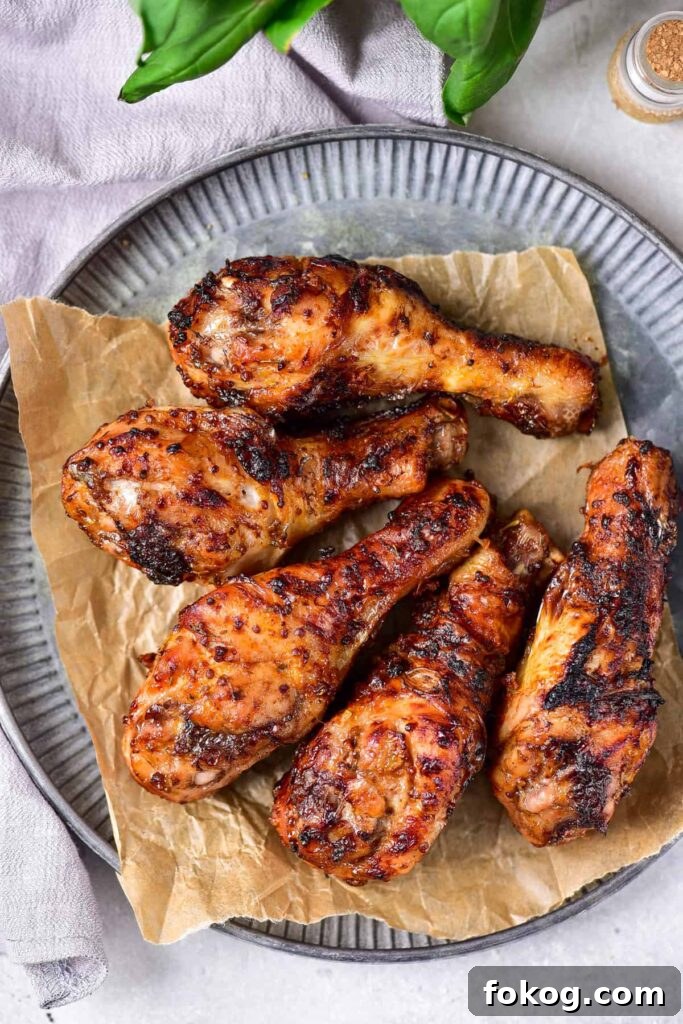 41 Juicy Chicken Drumstick Recipes You’ll Want Tonight 25 Maple Mustard Chicken Legs served on a grey plate