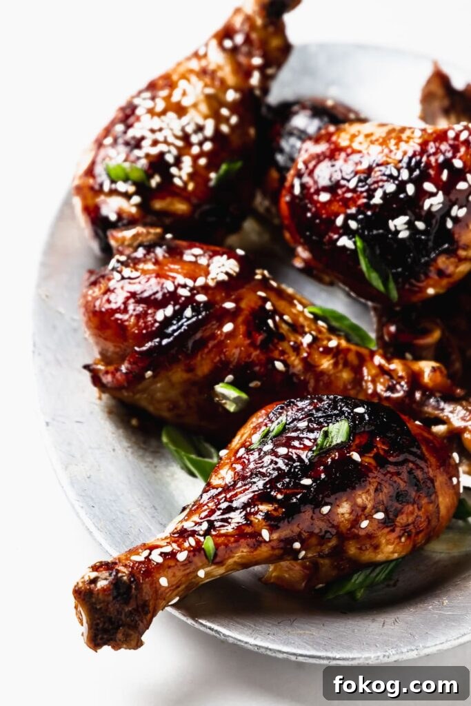 41 Juicy Chicken Drumstick Recipes You’ll Want Tonight 9 Sesame Soy Chicken Drumsticks stacked on a small plate