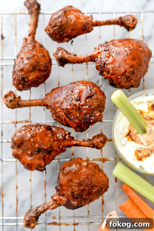 41 Juicy Chicken Drumstick Recipes You’ll Want Tonight 10 Buffalo Chicken Drumsticks on a wire rack with a dip