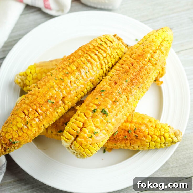4 Cajun Corn On The Cobs on white plate