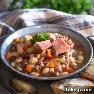 A bowl filled with ham, beans, carrots and celery.