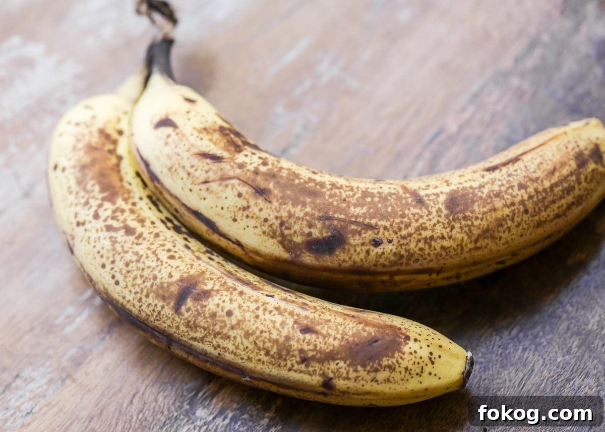 Salty & sweet peanut butter and banana smoothie makes a satisfying breakfast or afternoon snack, packed with protein and flavor! Two ripe bananas on a kitchen table.