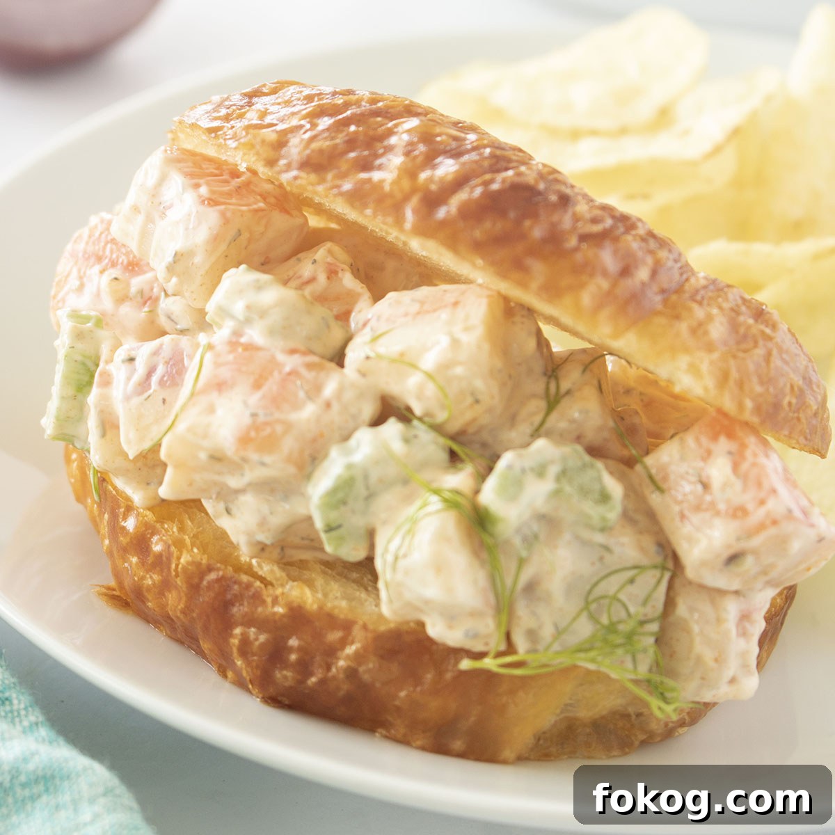 Crab Salad Sandwich on a white plate with potato chips.