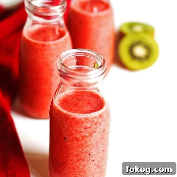 Smoothie in three glasses with sliced kiwi and a red napkin next the the glasses