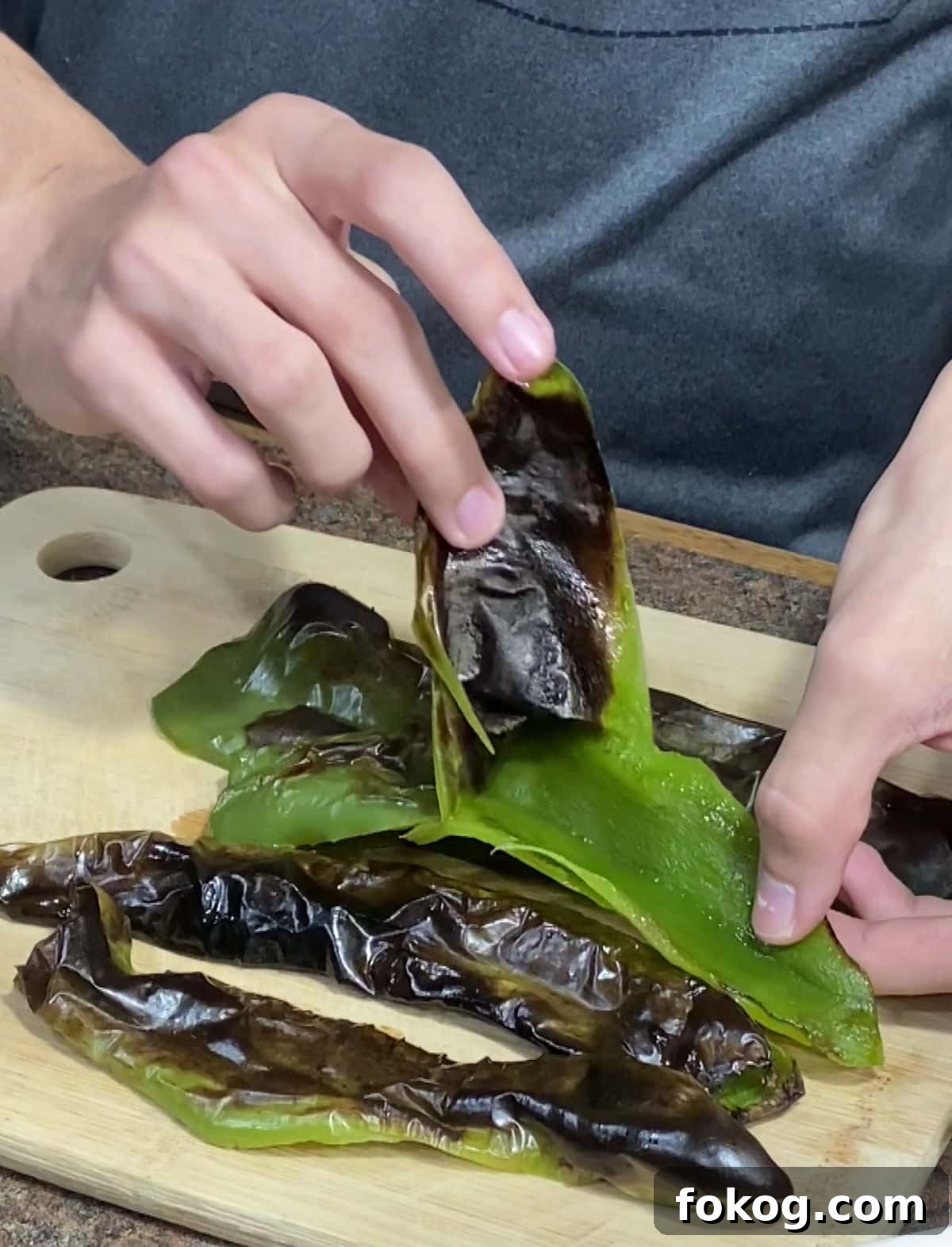 Chile Verde Pork Guisado Recipe 6 Peeling the charred skin from Anaheim peppers