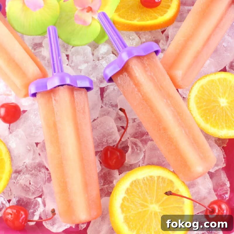 24+ Tropical Pineapple Juice Cocktail Recipes 12 Bahama Mama Popsicles on a bed of ice with orange slices and maraschino cherries