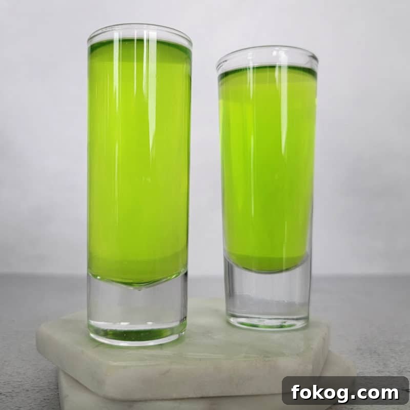 24+ Tropical Pineapple Juice Cocktail Recipes 5 Two bright green ninja turtle shots on white coasters