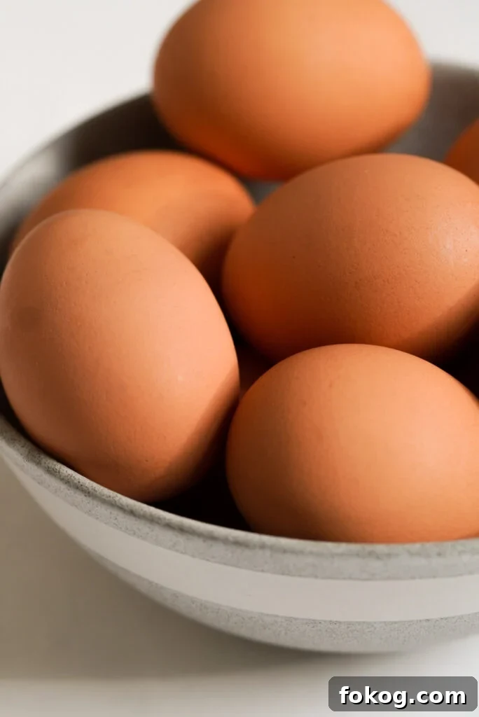 How to Make Soft-Boiled Eggs in an Air Fryer 5 close up shot of raw eggs in a bowl