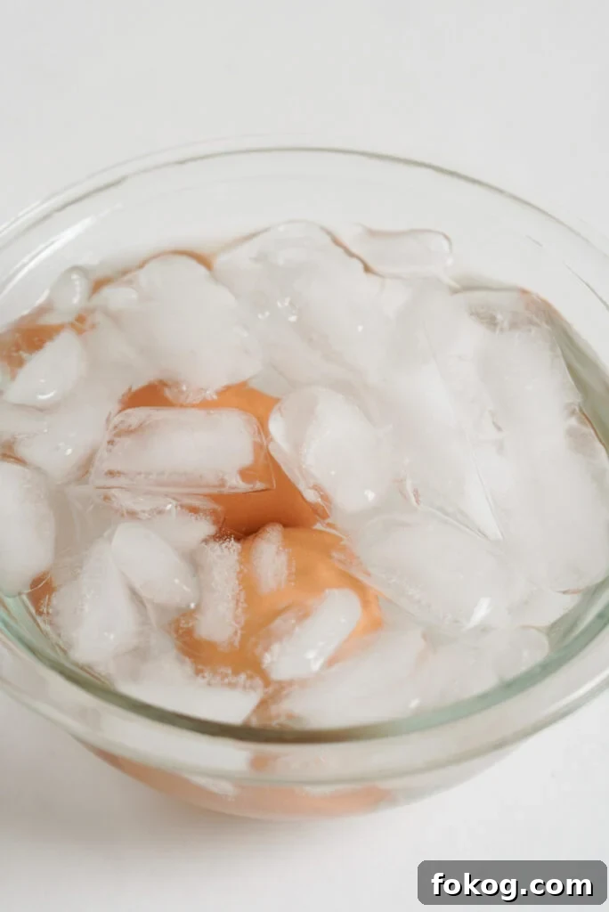 How to Make Soft-Boiled Eggs in an Air Fryer 8 air fried soft boiled eggs in a bowl of ice cold water