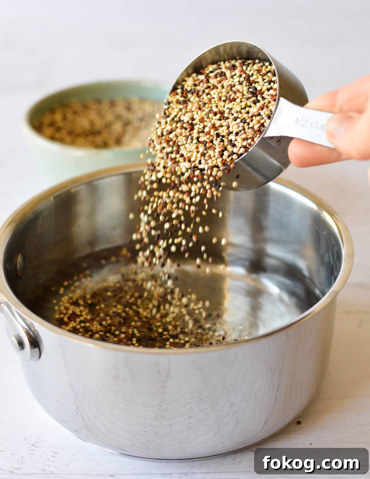 How to Cook Tri-Color Quinoa: Perfect Fluffy Results 4 pouring tri color quinoa into a saucepan.