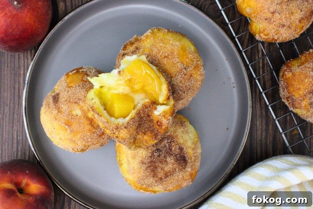 Air Fryer Peach Pie Biscuit Bombs - Quick Dessert 11 overhead view of air fryer peach pie biscuit bombs stacked up on a plate