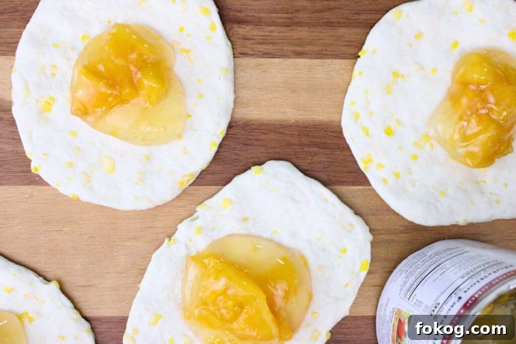 Air Fryer Peach Pie Biscuit Bombs - Quick Dessert 6 add peach pie filling into the center of each biscuit