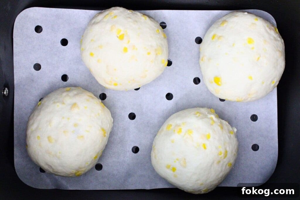 Air Fryer Peach Pie Biscuit Bombs - Quick Dessert 8 place filled peach biscuit bombs in air fryer basket