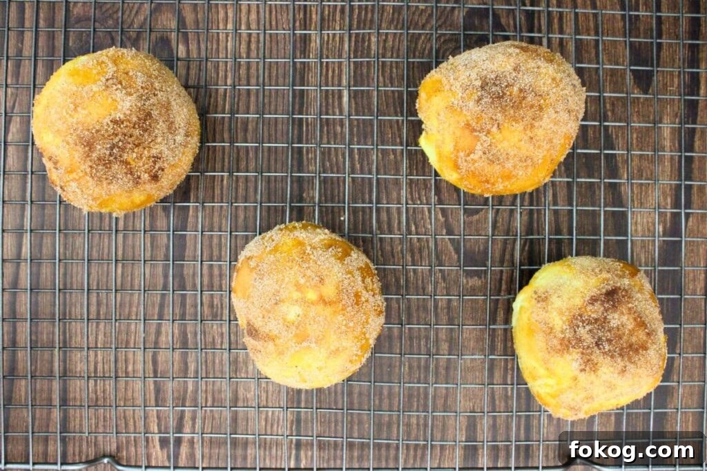 Air Fryer Peach Pie Biscuit Bombs - Quick Dessert 10 brush peach biscuit bombs with butter and dip in cinnamon sugar
